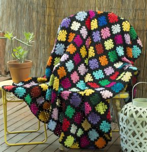 Rainbow Patchwork Rug with Blue, Red, Pink, Lilac, Yellow, Orange and Aqua Squares and Black Trim. Order by name "Joan".